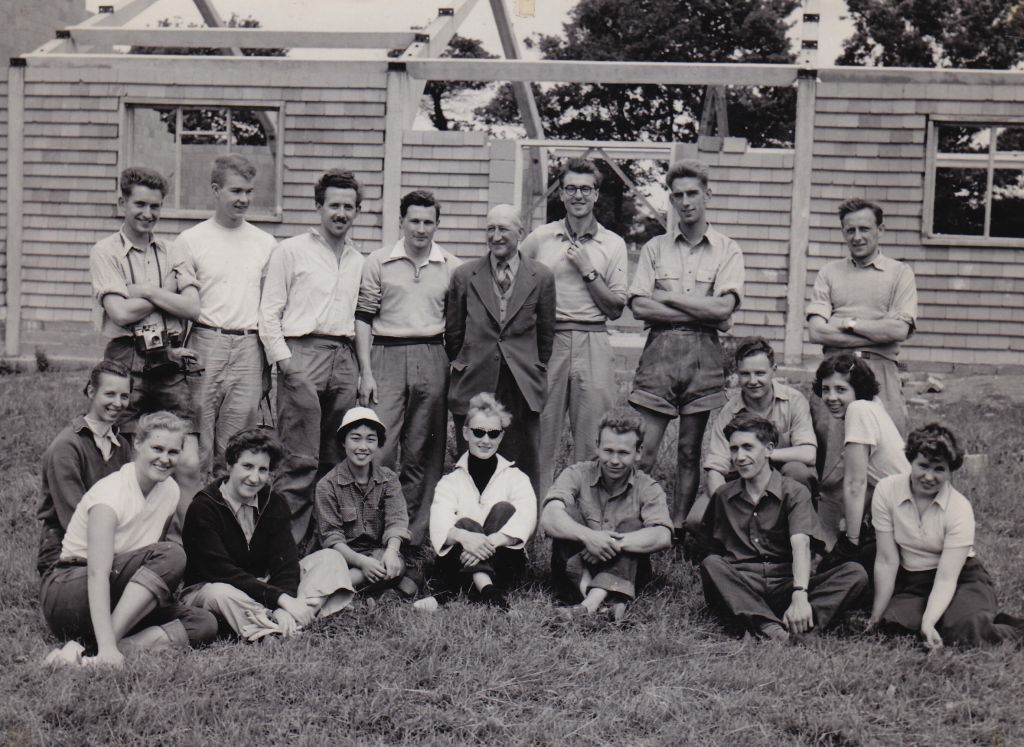 Campers gathered in front of the partially built building on the first morning, together with Mr Reginald Russell-Howes, the secretary of the village committee, (Photo: Suffolk Chronicle & Mercury)